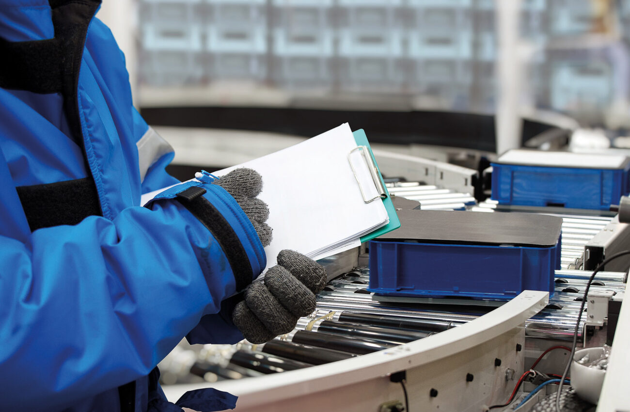 Closeup shooting hand of worker with clipboard checking plastic